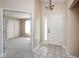 Bright entryway with tile floor, a chandelier, and doorway leading to a carpeted living area at 6105 Franklin Villas Way, Indianapolis, IN 46237
