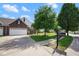 Desirable property showcasing a well-kept lawn, mature trees, and charming curb appeal at 6105 Franklin Villas Way, Indianapolis, IN 46237