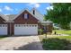 Charming brick home featuring a manicured lawn, a two-car garage, and tasteful landscaping at 6105 Franklin Villas Way, Indianapolis, IN 46237