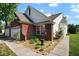 Charming exterior view features a brick facade, a 2-car garage and landscaped garden beds, enhancing curb appeal at 6105 Franklin Villas Way, Indianapolis, IN 46237