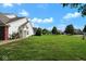 Well-manicured front lawn showcasing the landscape and curb appeal of the property on a bright day at 6105 Franklin Villas Way, Indianapolis, IN 46237