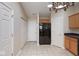 A kitchen view highlighting black refrigerator, light-colored cabinetry, and tile flooring at 6105 Franklin Villas Way, Indianapolis, IN 46237