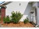 Beautiful landscaping features thriving rose bushes with vibrant red and yellow blossoms, enhancing the home's appeal at 6105 Franklin Villas Way, Indianapolis, IN 46237