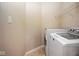 A well-lit laundry room features a washer, dryer, wire shelving, and neutral walls at 6105 Franklin Villas Way, Indianapolis, IN 46237