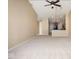 Open-concept living room featuring high ceilings, ceiling fan, and view into the kitchen at 6105 Franklin Villas Way, Indianapolis, IN 46237