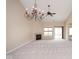 Living room featuring high ceilings, fireplace, large chandelier, carpet, and sliding glass door at 6105 Franklin Villas Way, Indianapolis, IN 46237
