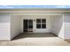 Outdoor patio with sliding glass door, an extra storage door and white vinyl siding at 6105 Franklin Villas Way, Indianapolis, IN 46237