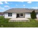 A beautiful backyard patio and home exterior, complemented by lush greenery and a concrete patio at 6105 Franklin Villas Way, Indianapolis, IN 46237