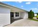 A covered patio featuring sliding glass doors, a window, a door and greenery, inviting relaxation and outdoor enjoyment at 6105 Franklin Villas Way, Indianapolis, IN 46237