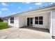 Covered patio featuring a sliding glass door, window, and a concrete surface, perfect for outdoor relaxation at 6105 Franklin Villas Way, Indianapolis, IN 46237
