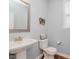 Clean half-bath with pedestal sink, toilet, and decorative artwork at 6337 Ederline Ln, Noblesville, IN 46062