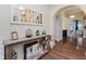 Foyer features hardwood floors, stylish mirror and view of arched hallway at 6337 Ederline Ln, Noblesville, IN 46062