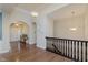 Upstairs hallway features hardwood floors, arched doorways, and decorative lighting at 6337 Ederline Ln, Noblesville, IN 46062