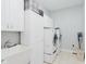 Functional laundry room featuring washer, dryer, sink, and ample storage at 6337 Ederline Ln, Noblesville, IN 46062