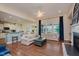Open-concept living room with large windows, fireplace, and seamless access to the kitchen and dining area at 6337 Ederline Ln, Noblesville, IN 46062