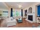 Cozy living room with fireplace, plush seating, and ample natural light at 6337 Ederline Ln, Noblesville, IN 46062