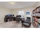 A home office with multiple computer setups, carpet flooring, and a built-in bookshelf at 6337 Ederline Ln, Noblesville, IN 46062