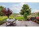 Stamped concrete patio boasts outdoor seating and beautiful views of the pond and manicured backyard at 6337 Ederline Ln, Noblesville, IN 46062