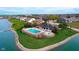 Aerial view of a community pool and lounge area overlooking a scenic lake at 6337 Ederline Ln, Noblesville, IN 46062