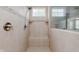 Modern walk-in shower with bench seating, hand-held sprayer, and neutral tile at 6337 Ederline Ln, Noblesville, IN 46062