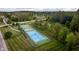 Aerial view of tennis and basketball courts with manicured lawns in a well maintained community at 6337 Ederline Ln, Noblesville, IN 46062