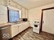 Functional kitchen with white cabinets, double sink, and essential appliances at 640 S Sycamore St, Martinsville, IN 46151