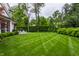 Well-manicured backyard featuring a lush lawn and patio seating area, perfect for outdoor entertaining at 6450 Holliday E Dr, Indianapolis, IN 46260