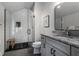 Modern bathroom featuring glass-enclosed shower, granite vanity, and stylish fixtures at 6450 Holliday E Dr, Indianapolis, IN 46260
