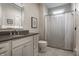 Bright bathroom featuring a granite countertop, white cabinets, and stylish geometric tile floor at 6450 Holliday E Dr, Indianapolis, IN 46260