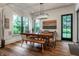 Bright dining room with large windows, a wooden table, and stylish light fixture at 6450 Holliday E Dr, Indianapolis, IN 46260