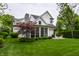 Beautiful home exterior with a well-maintained lawn, screened-in porch, and patio at 6450 Holliday E Dr, Indianapolis, IN 46260
