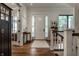 Bright foyer with hardwood floors, a white front door, and staircase with white railings at 6450 Holliday E Dr, Indianapolis, IN 46260