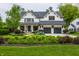 Charming two-story white home featuring a well-manicured lawn and a two-car garage at 6450 Holliday E Dr, Indianapolis, IN 46260