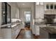 Extended galley kitchen with marble countertops, stainless appliances and white cabinets at 6450 Holliday E Dr, Indianapolis, IN 46260