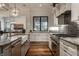 Modern kitchen with white cabinets, marble countertops, a farmhouse sink and stainless steel appliances at 6450 Holliday E Dr, Indianapolis, IN 46260