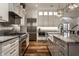 Bright kitchen featuring white cabinetry, stainless steel appliances, and marble countertops at 6450 Holliday E Dr, Indianapolis, IN 46260