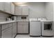 Convenient laundry room equipped with modern washer, dryer, ample storage, and a sink at 6450 Holliday E Dr, Indianapolis, IN 46260