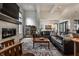 Spacious living room featuring a stone fireplace, a large leather couch, and hardwood floors at 6450 Holliday E Dr, Indianapolis, IN 46260