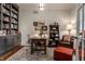 Cozy home office with built-in bookshelves, a desk, and a comfortable reading chair at 6450 Holliday E Dr, Indianapolis, IN 46260
