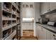 Walk-in pantry with custom shelves and cabinets for storing food and small appliances at 6450 Holliday E Dr, Indianapolis, IN 46260