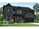 New construction two-story home featuring a two-car garage and craftsman-style details with a professionally landscaped lawn at 6462 Stone Side Dr, Plainfield, IN 46168