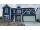 Charming two-story home with a blue exterior and a two-car garage with appealing architectural details at 6462 Stone Side Dr, Plainfield, IN 46168
