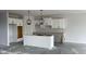 Spacious kitchen with ample cabinet space and a central island awaiting finishing touches at 6462 Stone Side Dr, Plainfield, IN 46168