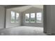 Living room with a vaulted ceiling, large windows, and natural light, creating a bright and welcoming atmosphere at 6462 Stone Side Dr, Plainfield, IN 46168