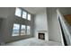 Bright, expansive living room with a fireplace and large windows, offering ample light at 6462 Stone Side Dr, Plainfield, IN 46168