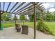 Backyard patio area with wicker chairs and a wooden pergola at 65 Millet Ct, Danville, IN 46122