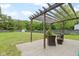 Backyard patio area featuring wicker furniture and a wooden pergola at 65 Millet Ct, Danville, IN 46122