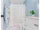 Bathroom featuring blue walls, white vanity, and shower with a textured white curtain at 65 Millet Ct, Danville, IN 46122