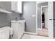 Bright bathroom with white vanity, toilet, and a glimpse into an adjacent room showcasing the home's layout at 65 Millet Ct, Danville, IN 46122