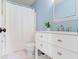 Bright bathroom with white vanity and a shower with a white curtain at 65 Millet Ct, Danville, IN 46122